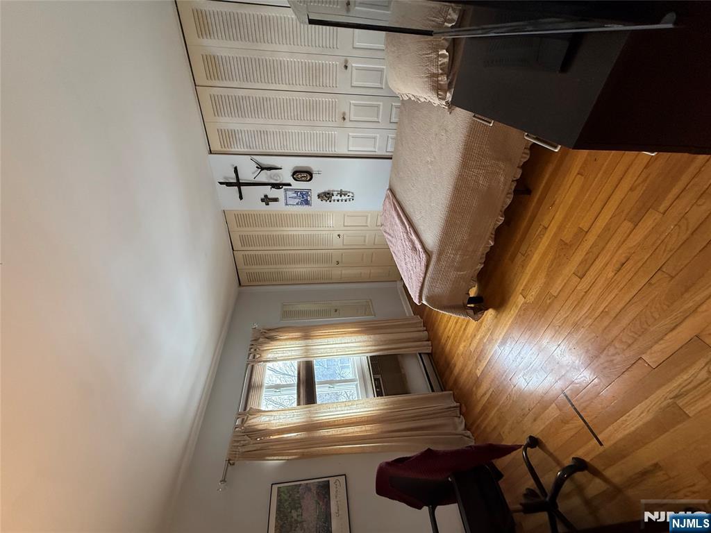 101 Orient Way, Unit 2C1 Rutherford, NJ 07070 - Photo 10 of 12 a bedroom with a bed and wooden floor