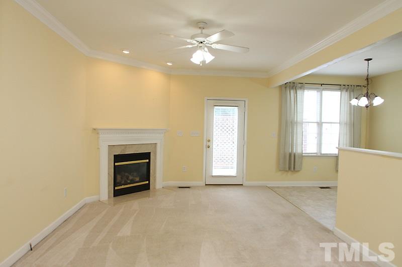 5425 Goldenglow Way Raleigh, NC 27606 - Photo 2 of 17 an empty room with windows and fireplace