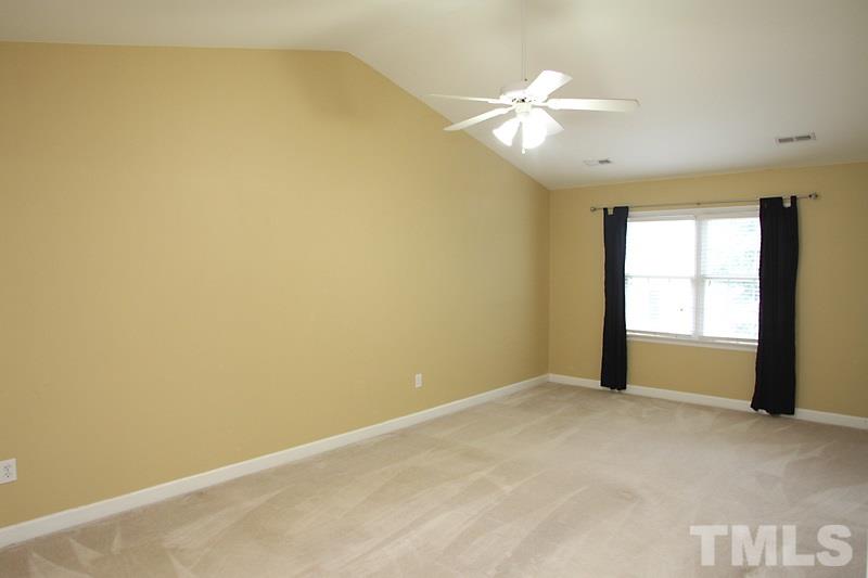 5425 Goldenglow Way Raleigh, NC 27606 - Photo 11 of 17 an empty room with a window and a fan