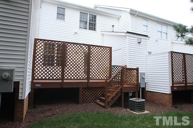 5425 Goldenglow Way Raleigh, NC 27606 - Photo 17 of 17 a view of a deck with a table and chairs