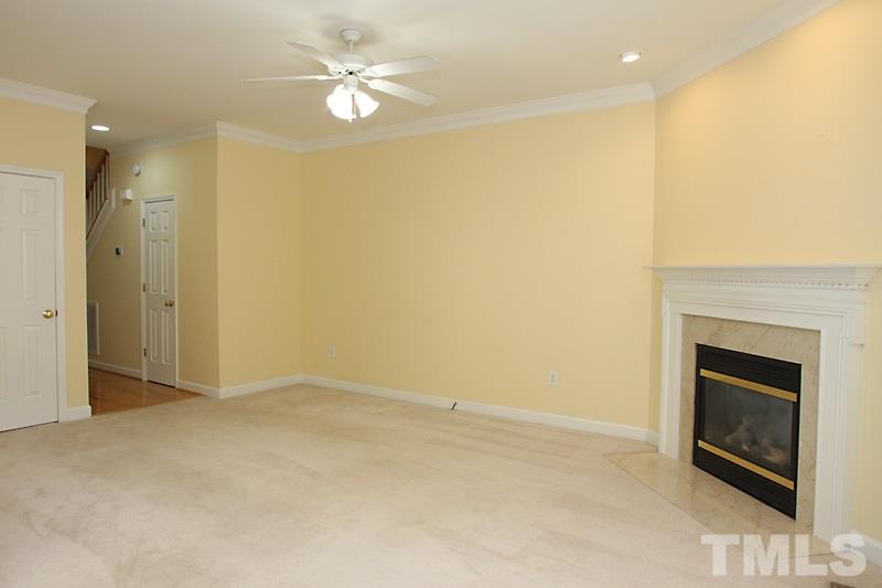 5425 Goldenglow Way Raleigh, NC 27606 - Photo 3 of 17 a view of an empty room with a fireplace