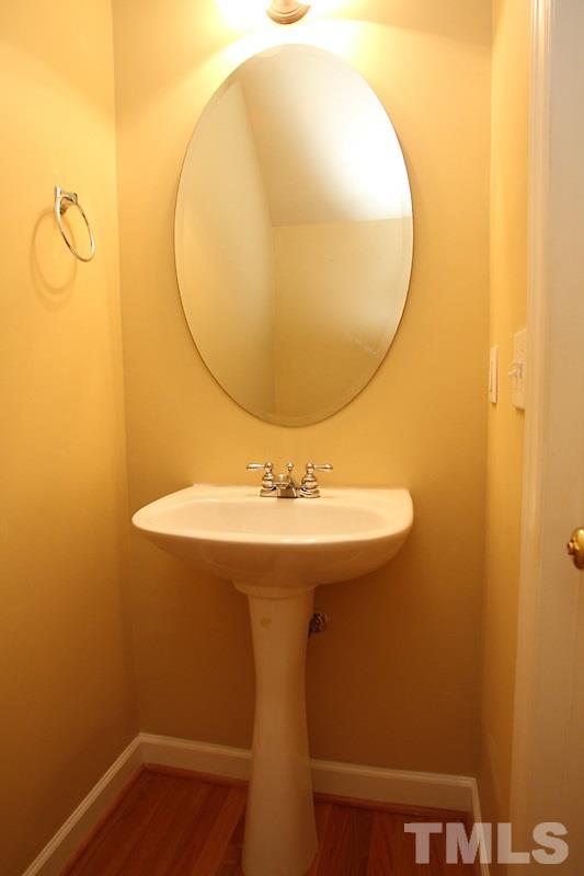 5425 Goldenglow Way Raleigh, NC 27606 - Photo 7 of 17 a bathroom with a sink and mirror