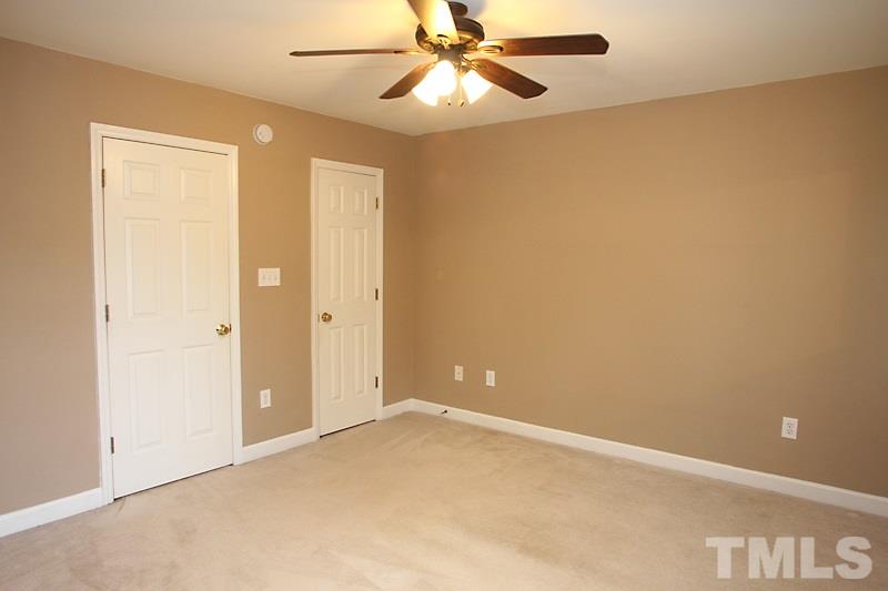 5425 Goldenglow Way Raleigh, NC 27606 - Photo 9 of 17 an empty room with a ceiling fan and a window