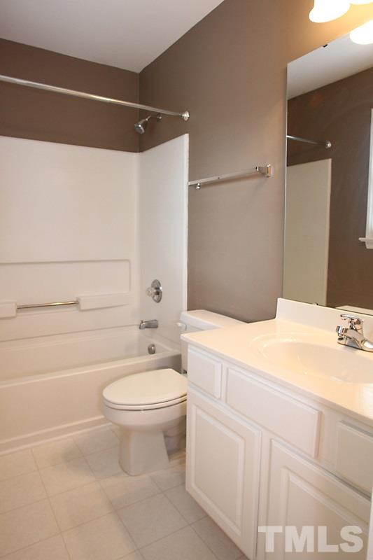 5425 Goldenglow Way Raleigh, NC 27606 - Photo 10 of 17 a bathroom with a sink a toilet and shower