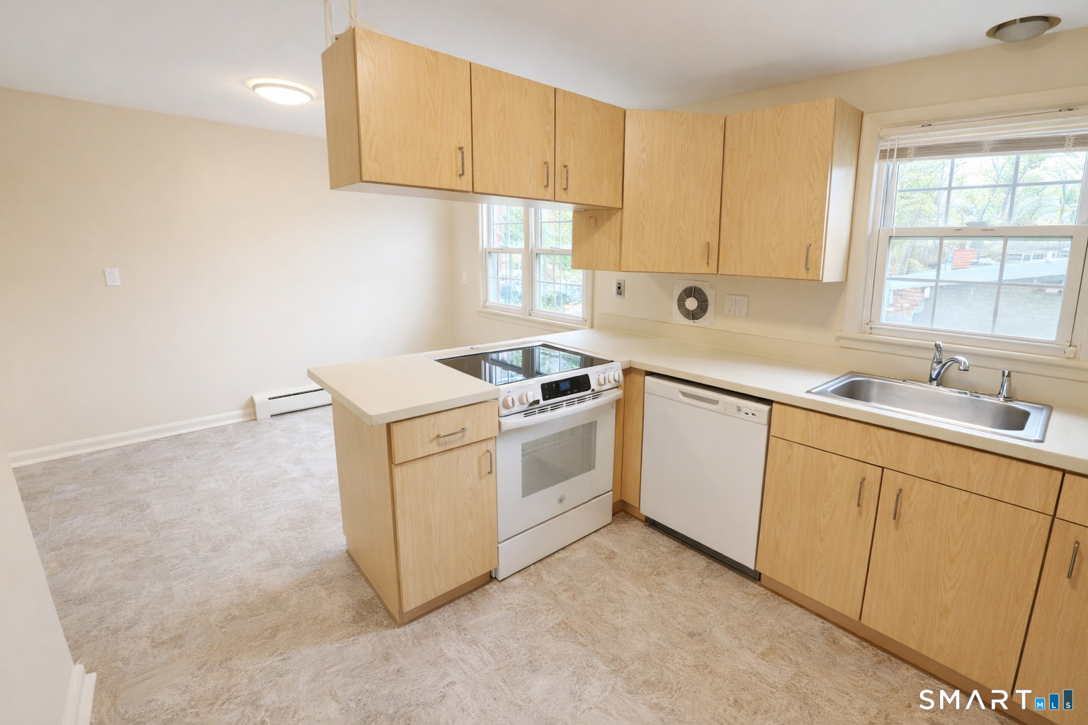 949 Hopmeadow Street, Unit 28 Simsbury, CT 06070 - Photo 1 of 10 a kitchen with white cabinets and white appliances