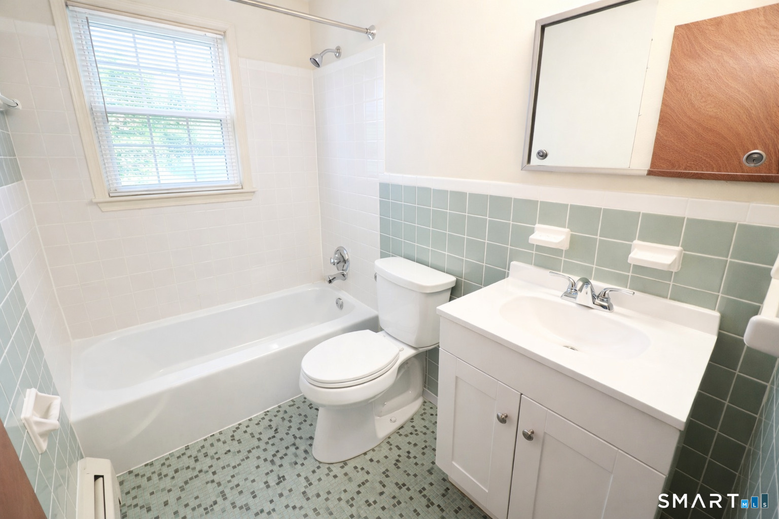 949 Hopmeadow Street, Unit 28 Simsbury, CT 06070 - Photo 3 of 10 a bathroom with a sink toilet a mirror and bathtub