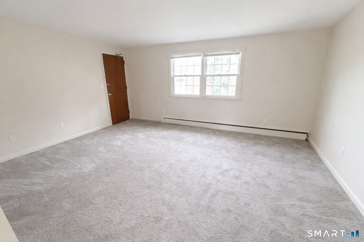 949 Hopmeadow Street, Unit 28 Simsbury, CT 06070 - Photo 6 of 10 an empty room with windows