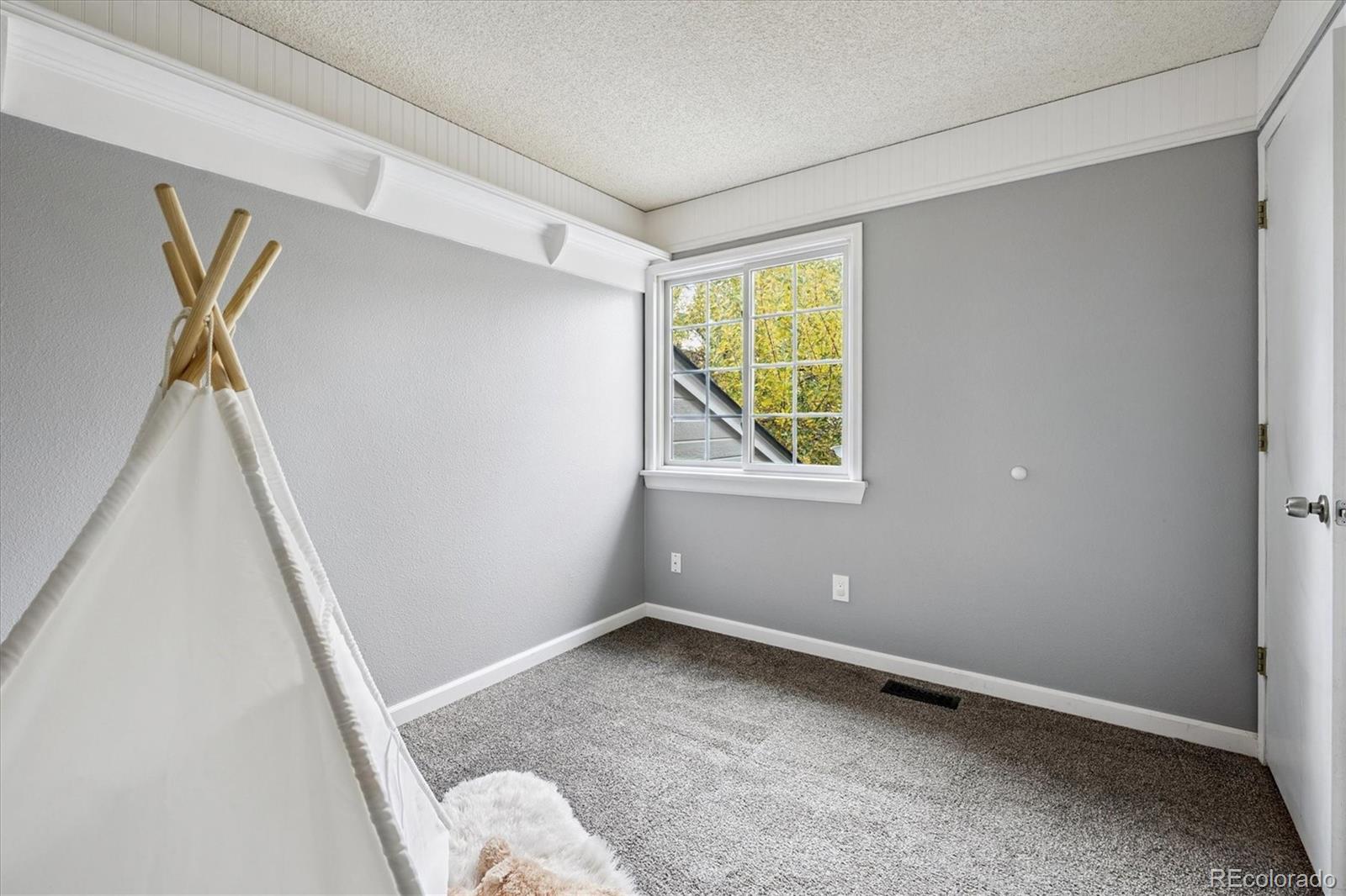 669 Walden Court Highlands Ranch, CO 80126 - Photo 18 of 34 a view of room with window and a ceiling fan