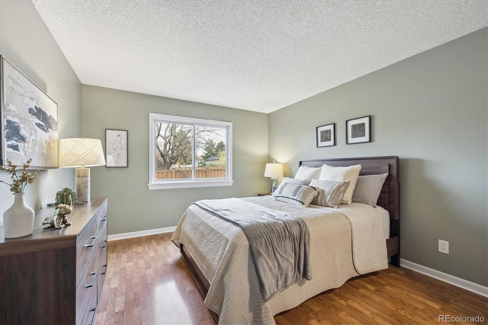 669 Walden Court Highlands Ranch, CO 80126 - Photo 20 of 34 a bedroom with a bed and a window