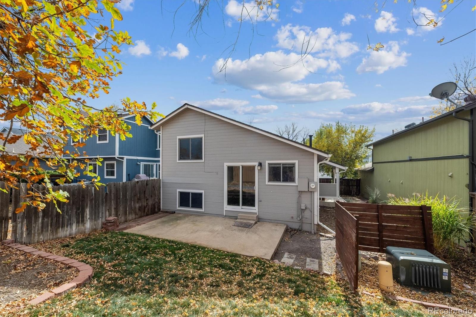669 Walden Court Highlands Ranch, CO 80126 - Photo 26 of 34 a backyard of a house with table and chairs