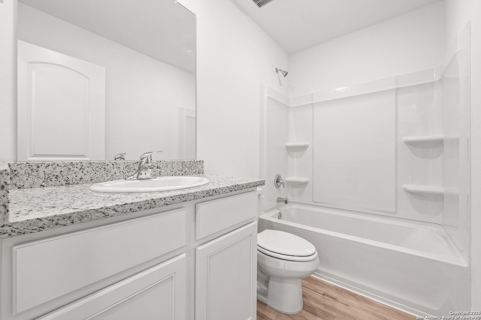 16108 Farmer Lytle, TX 78052 - Photo 14 of 27 a bathroom with a granite countertop toilet a sink and a bathtub