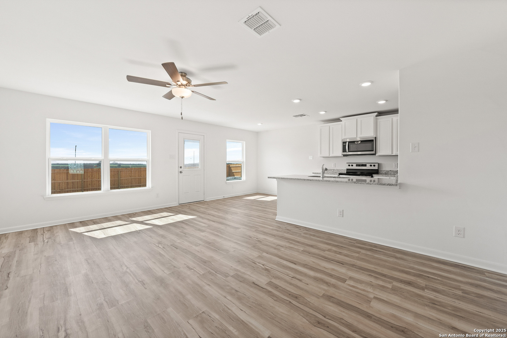 16108 Farmer Lytle, TX 78052 - Photo 4 of 27 a view of kitchen with granite countertop cabinets and wooden floor