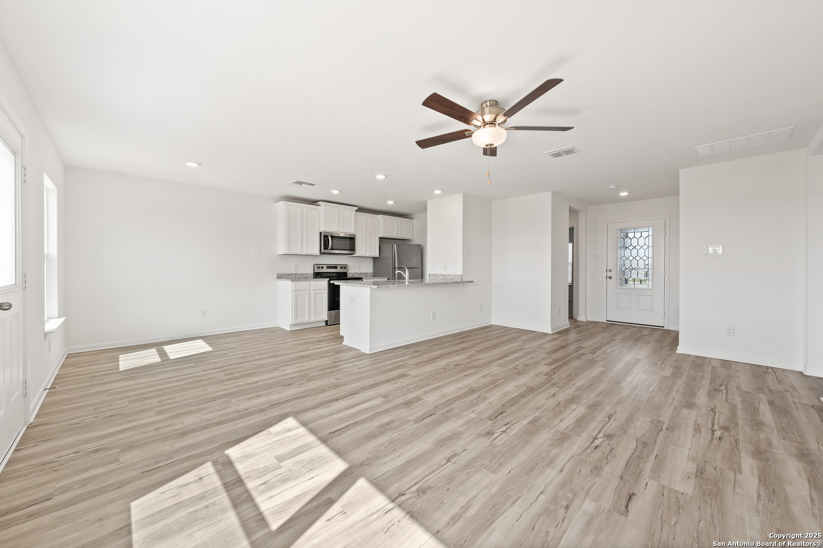 16108 Farmer Lytle, TX 78052 - Photo 5 of 27 a view of a kitchen with a sink and wooden floor