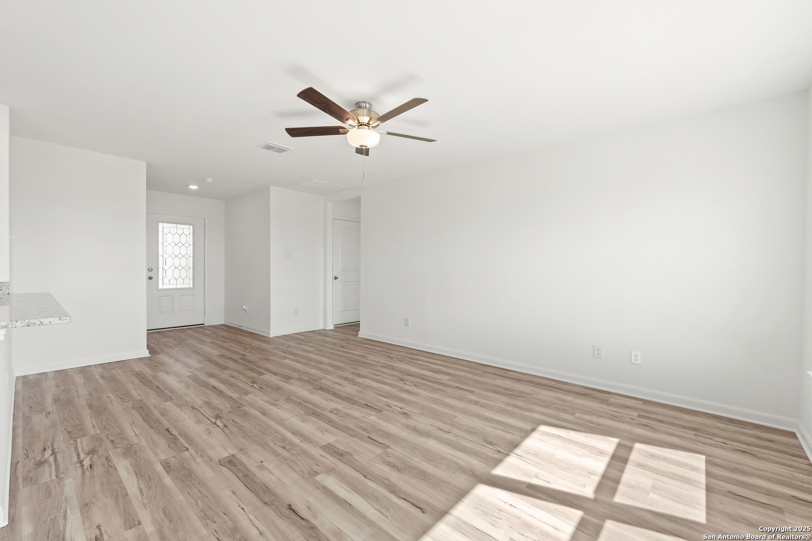 16108 Farmer Lytle, TX 78052 - Photo 6 of 27 a view of empty room with wooden floor and fan