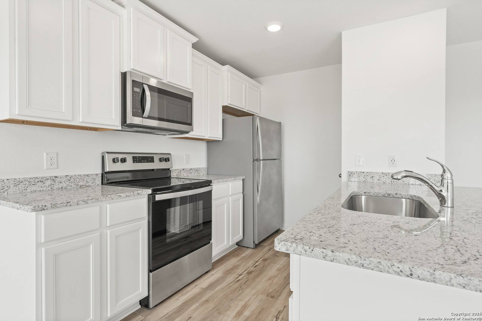 16108 Farmer Lytle, TX 78052 - Photo 7 of 27 a kitchen with stainless steel appliances granite countertop a sink and a refrigerator