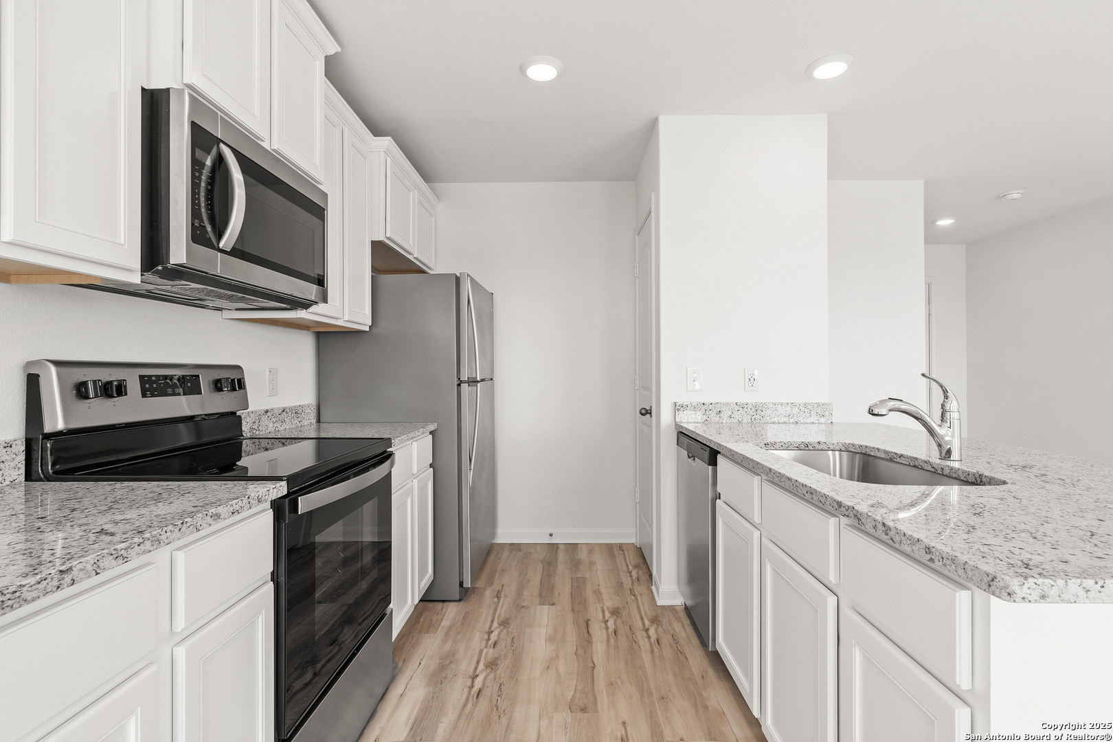 16108 Farmer Lytle, TX 78052 - Photo 9 of 27 a kitchen with stainless steel appliances granite countertop a sink stove and refrigerator