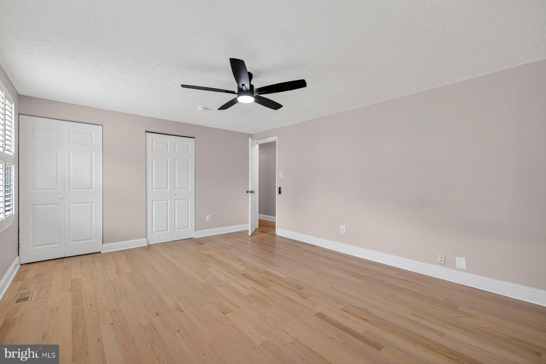 7518 Candytuft Court Springfield, VA 22153 - Photo 22 of 47 a view of empty room with wooden floor and ceiling fan