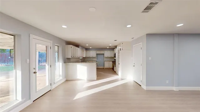 a view of kitchen with refrigerator sink and cabinets