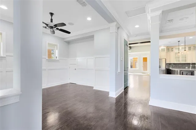 a view of a kitchen with wooden floor and a refrigerator