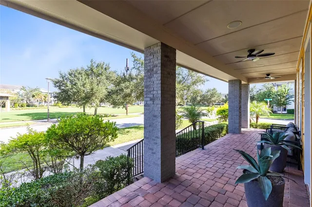 a view of a porch with furniture and garden