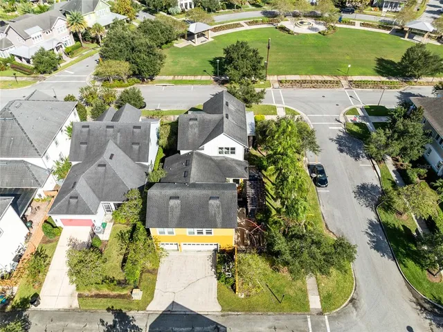 an aerial view of residential houses with outdoor space and swimming pool