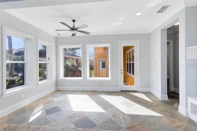 a view of a livingroom with a ceiling fan and window