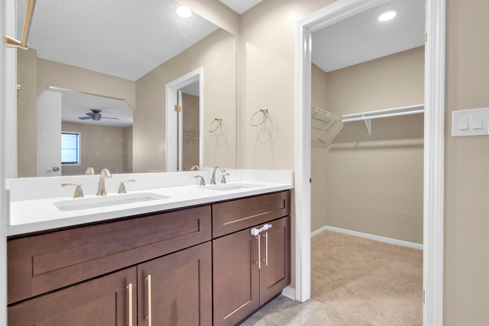 9242 Gross Point Road, Unit 310 Skokie, IL 60077 - Photo 13 of 18 a bathroom with a double vanity sink a mirror and a