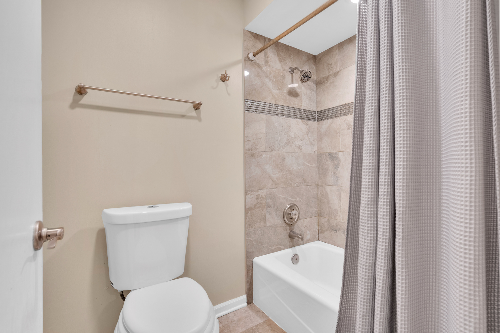 9242 Gross Point Road, Unit 310 Skokie, IL 60077 - Photo 14 of 18 a white toilet sitting next to a bath tub