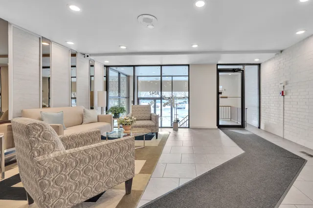 a living room with furniture and large windows