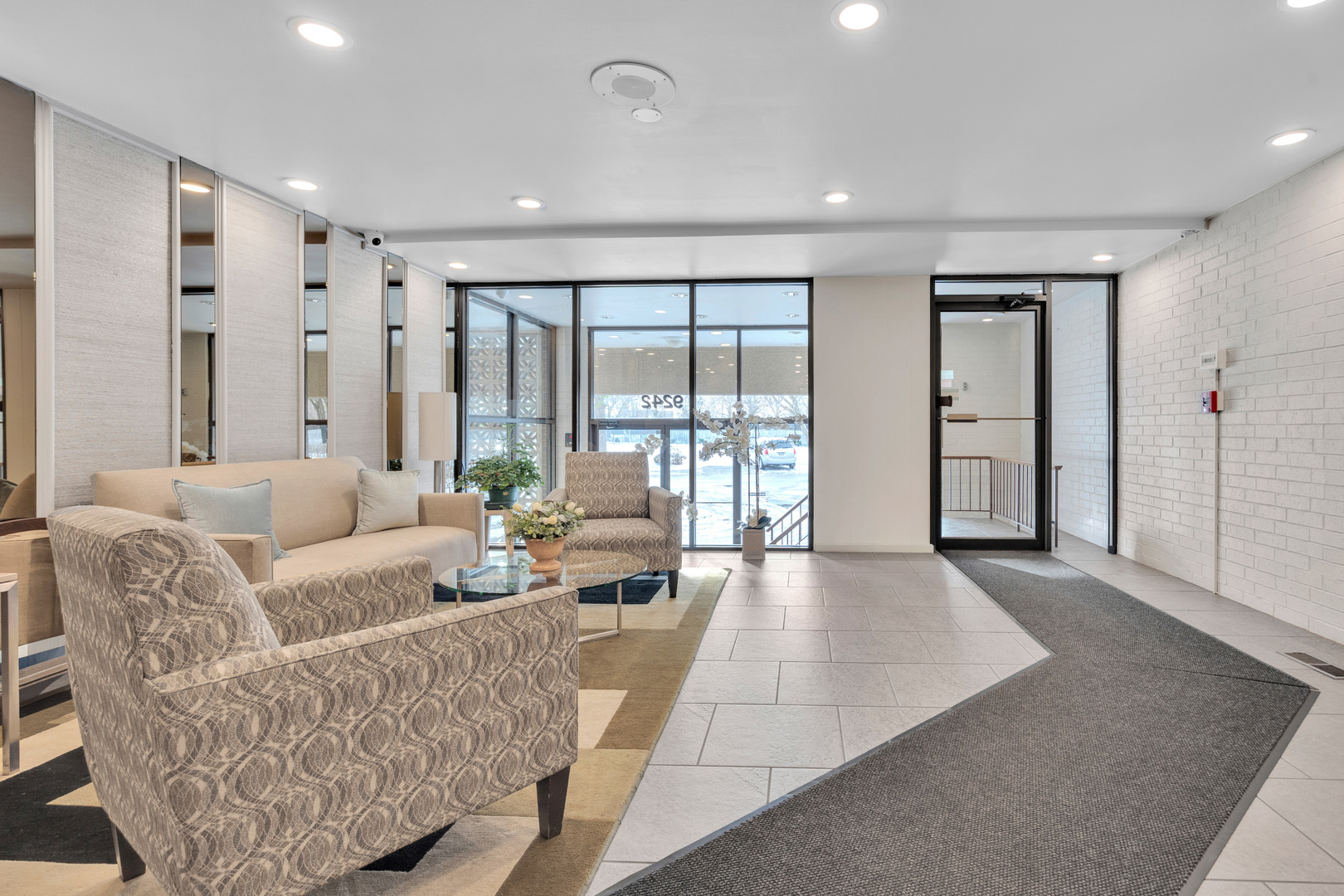 9242 Gross Point Road, Unit 310 Skokie, IL 60077 - Photo 16 of 18 a living room with furniture and large windows