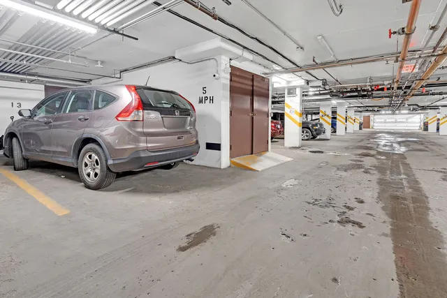 a view of parking garage with cars parked
