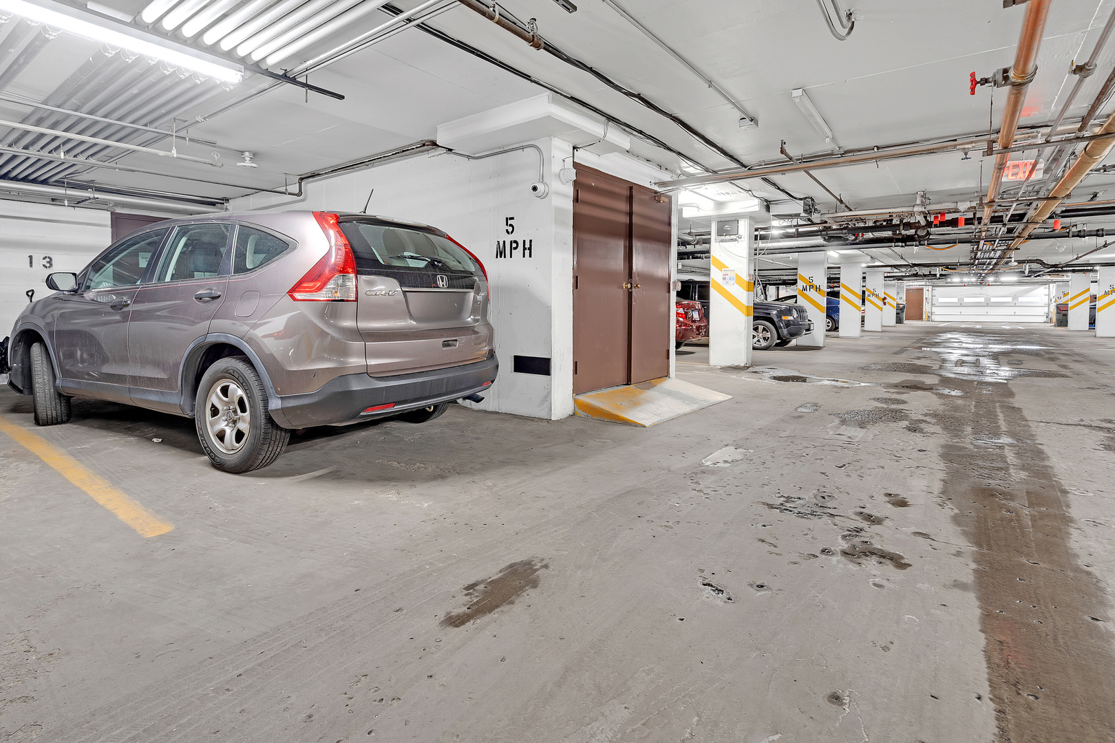 9242 Gross Point Road, Unit 310 Skokie, IL 60077 - Photo 17 of 18 a view of parking garage with cars parked