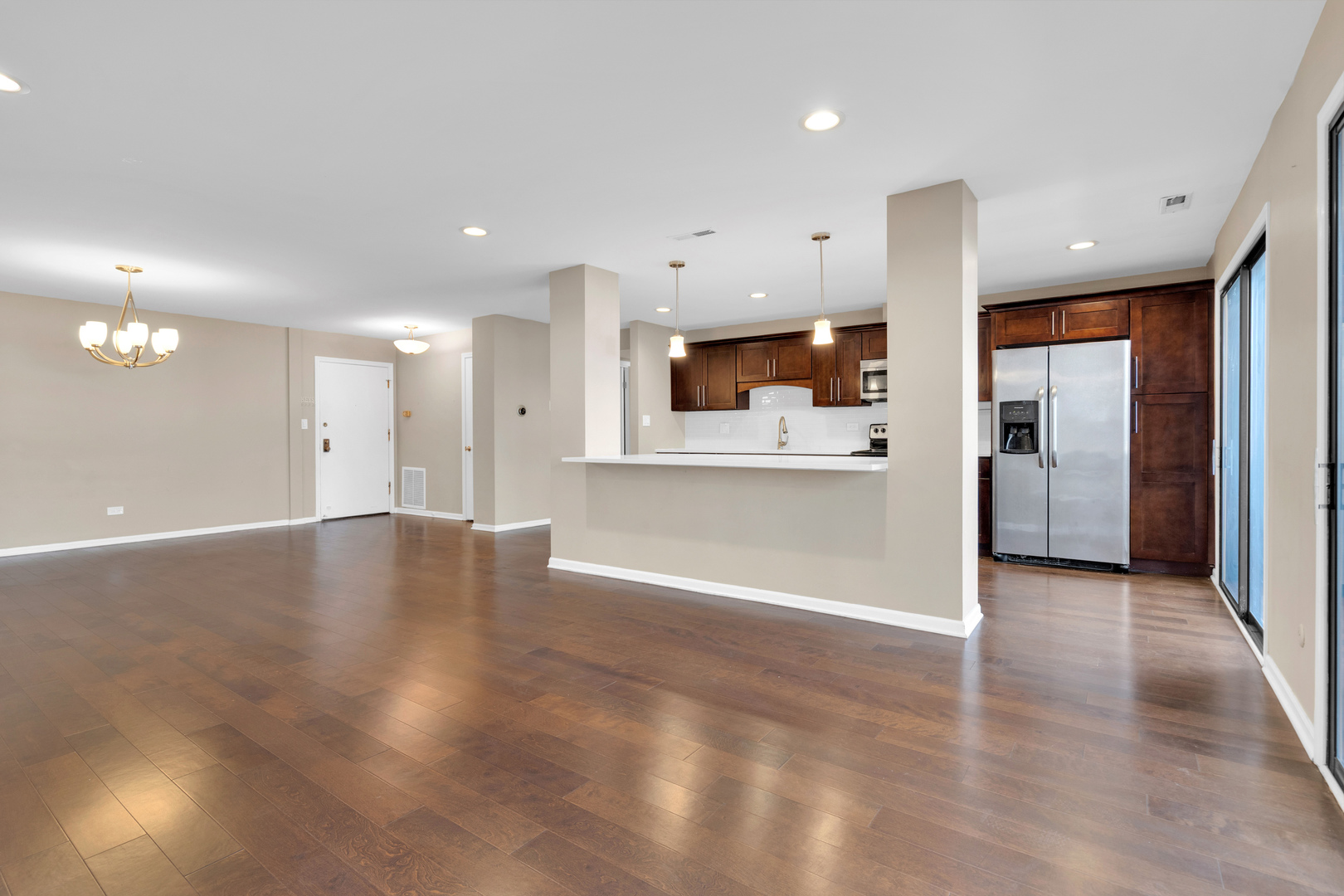 9242 Gross Point Road, Unit 310 Skokie, IL 60077 - Photo 6 of 18 a view of a kitchen with a refrigerator and a sink