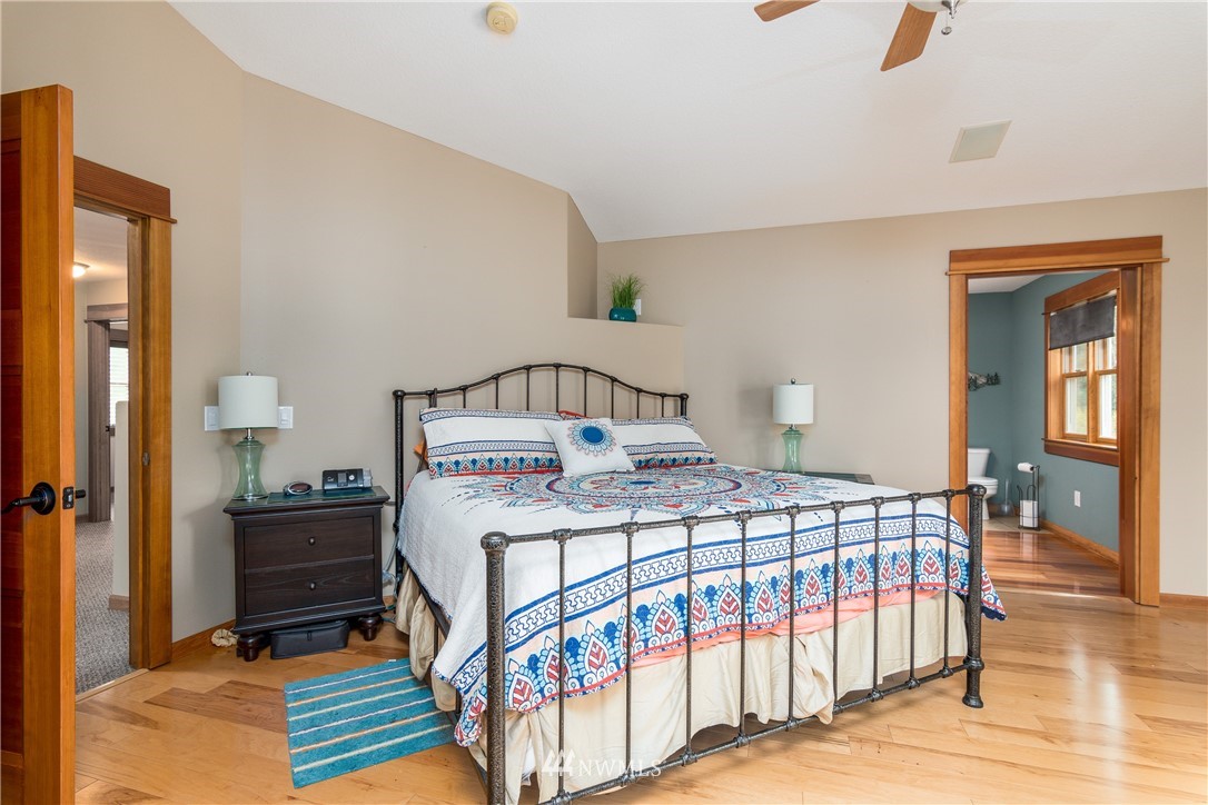 6845 Willow Grove Road Longview, WA 98632 - Photo 13 of 30 a bedroom with a bed a mirror and desk