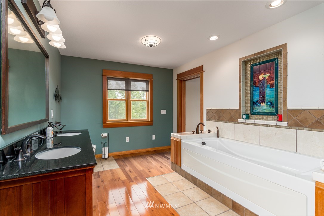 6845 Willow Grove Road Longview, WA 98632 - Photo 15 of 30 a spacious bathroom with sinks mirror and a bathtub