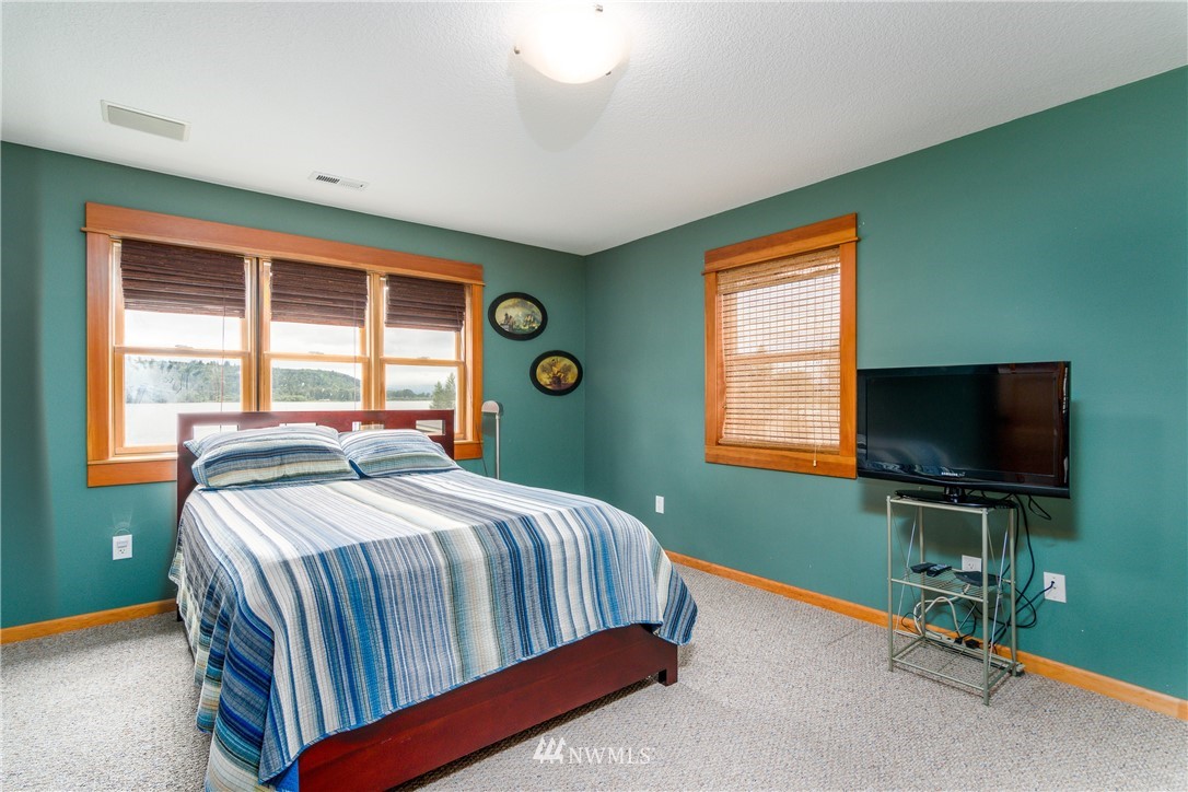 6845 Willow Grove Road Longview, WA 98632 - Photo 18 of 30 a bedroom with a bed and a flat screen tv