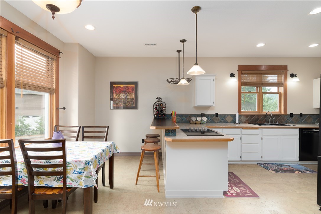 6845 Willow Grove Road Longview, WA 98632 - Photo 4 of 30 a kitchen with a table chairs stove and cabinets