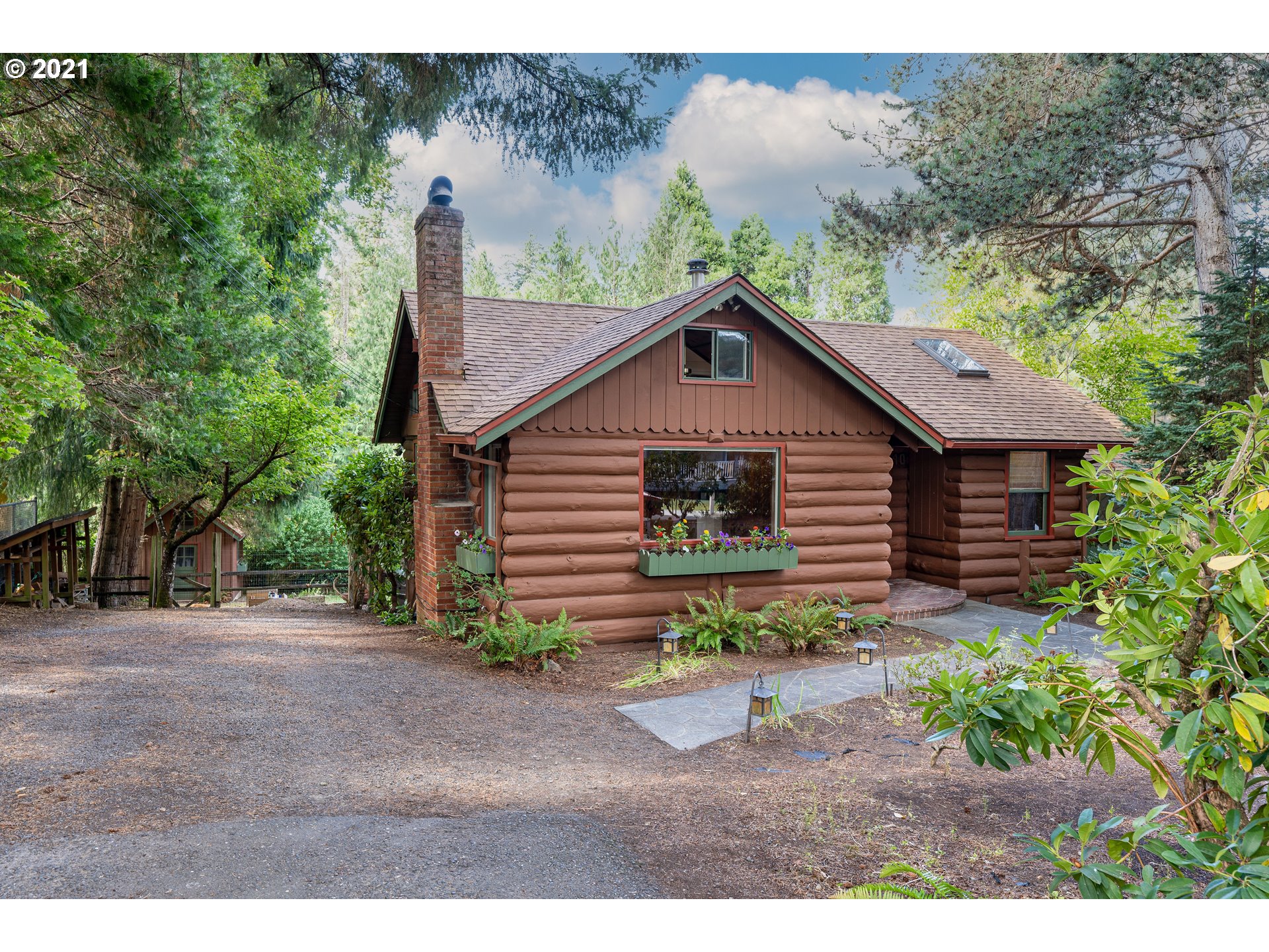 3740 Southwest Caldew Street Portland, OR 97219 - Photo 1 of 28 a front view of a house with garden