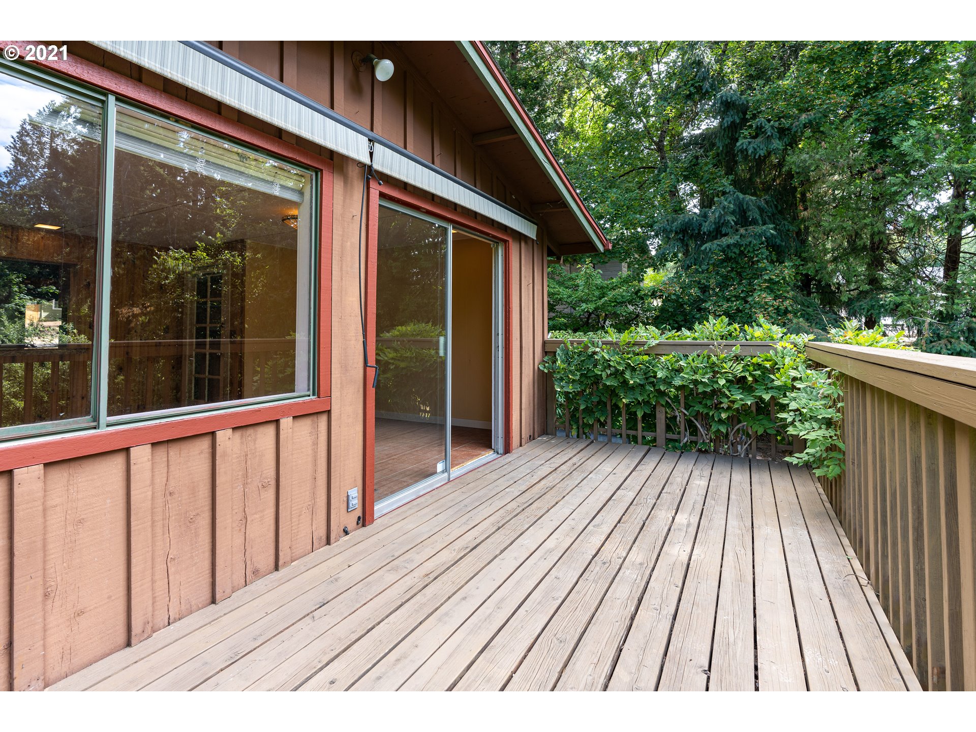 3740 Southwest Caldew Street Portland, OR 97219 - Photo 26 of 28 a view of backyard with a deck and wooden floor