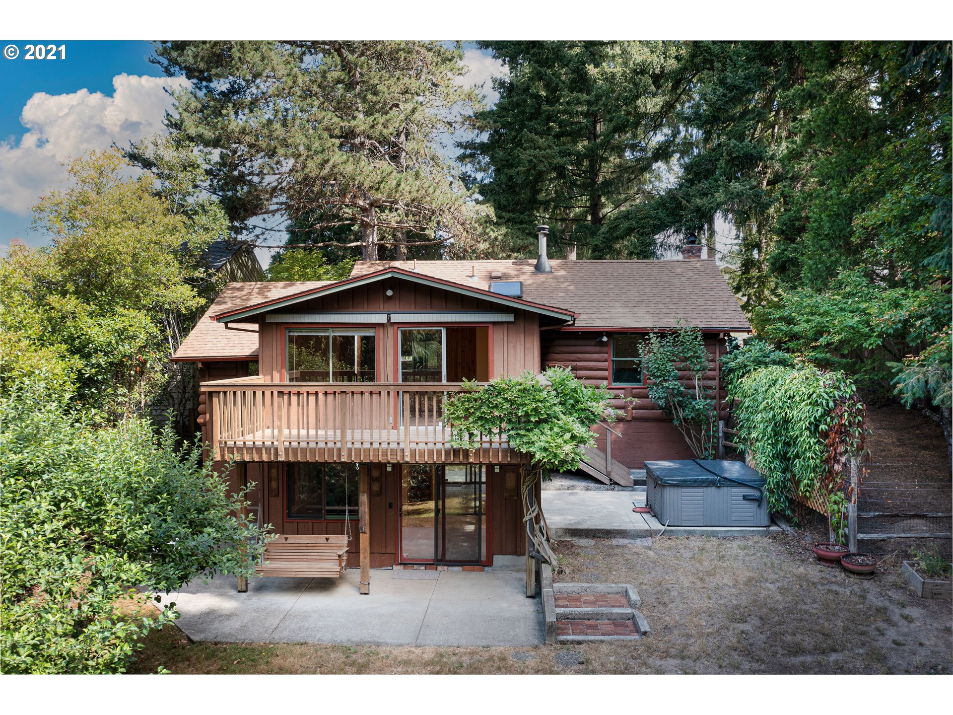 3740 Southwest Caldew Street Portland, OR 97219 - Photo 27 of 28 a house with lots of trees in the background