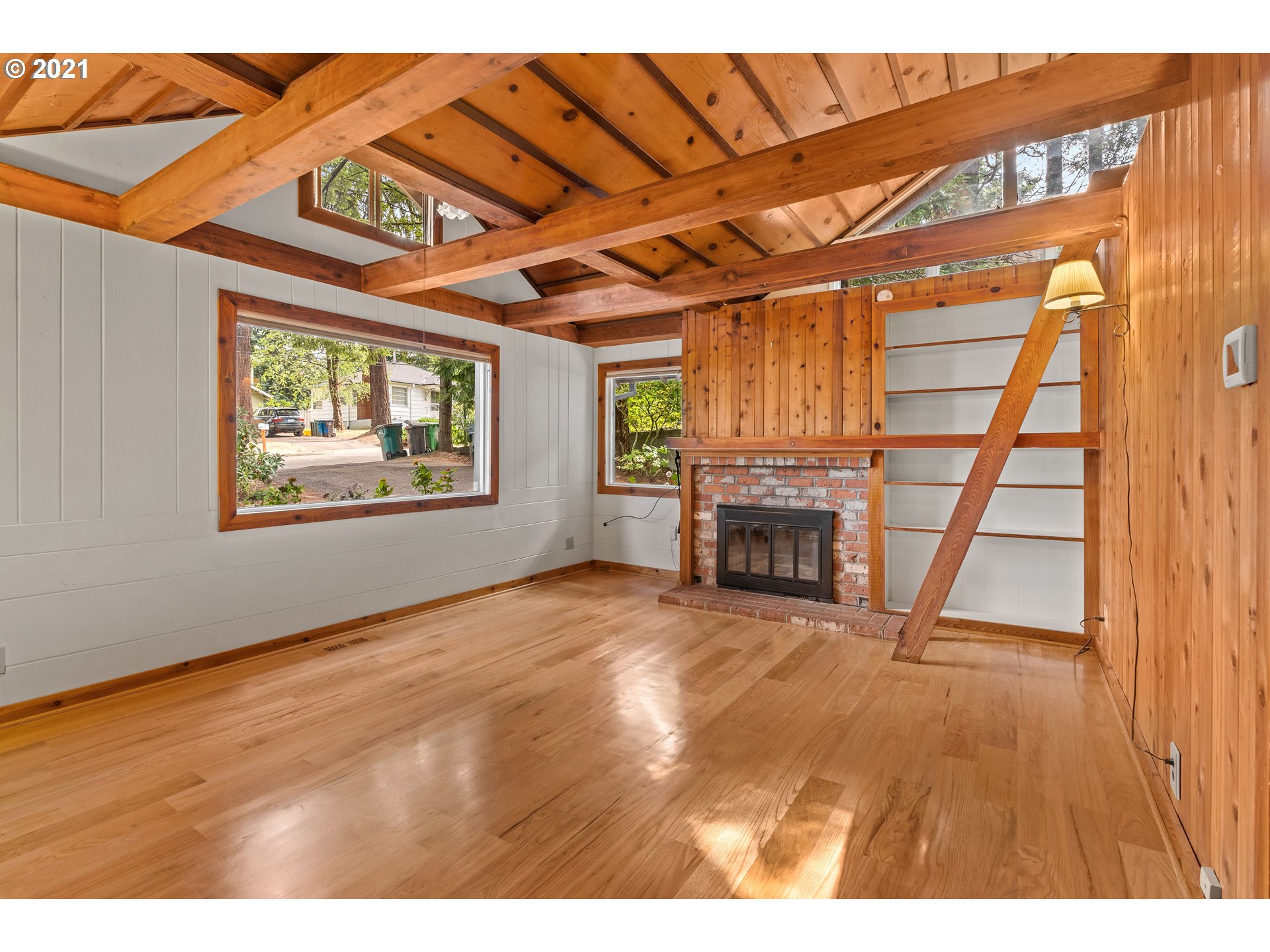 3740 Southwest Caldew Street Portland, OR 97219 - Photo 5 of 28 a view of an empty room with a fireplace and a window
