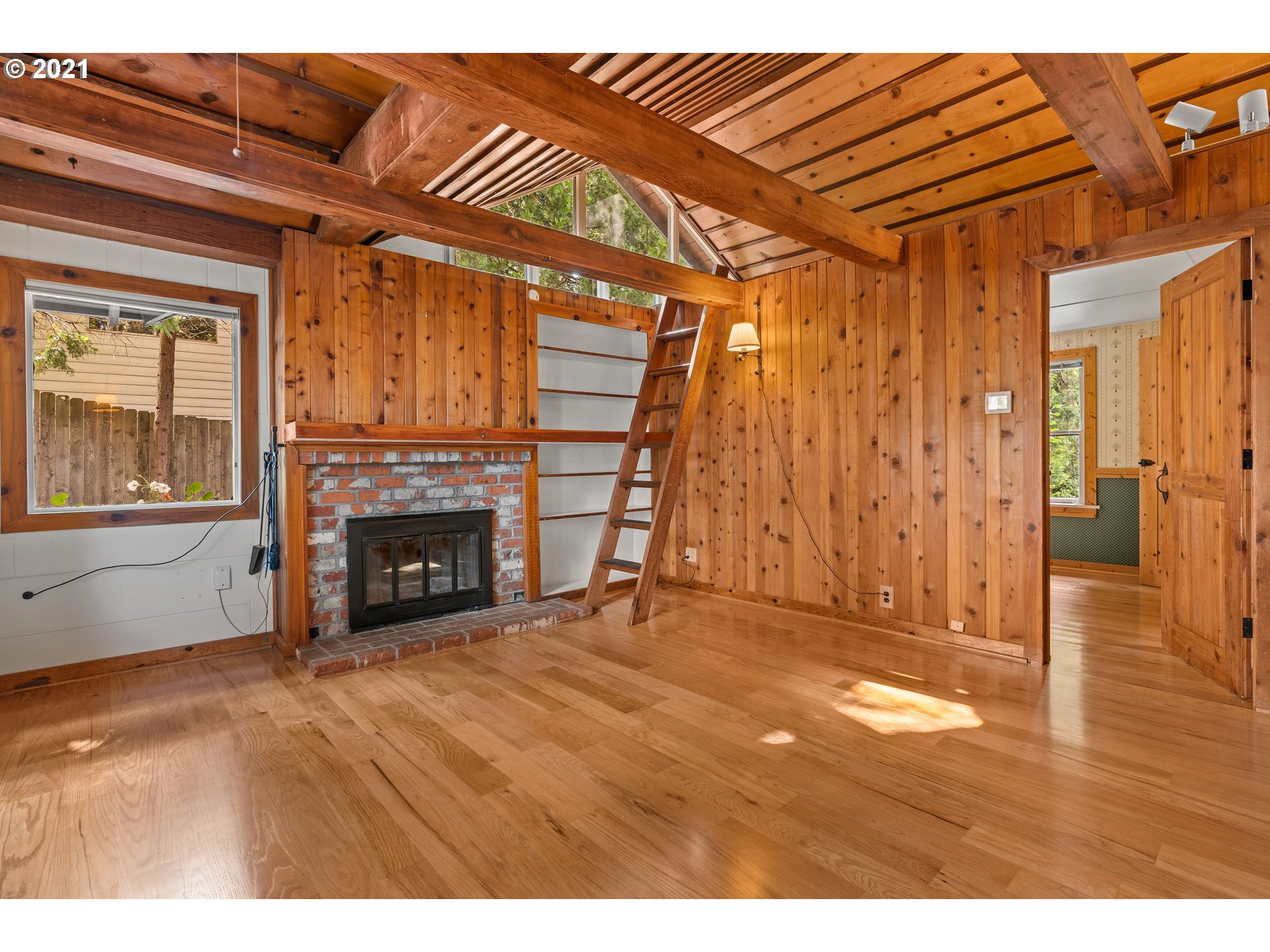 3740 Southwest Caldew Street Portland, OR 97219 - Photo 7 of 28 a view of empty room with wooden floor and fireplace