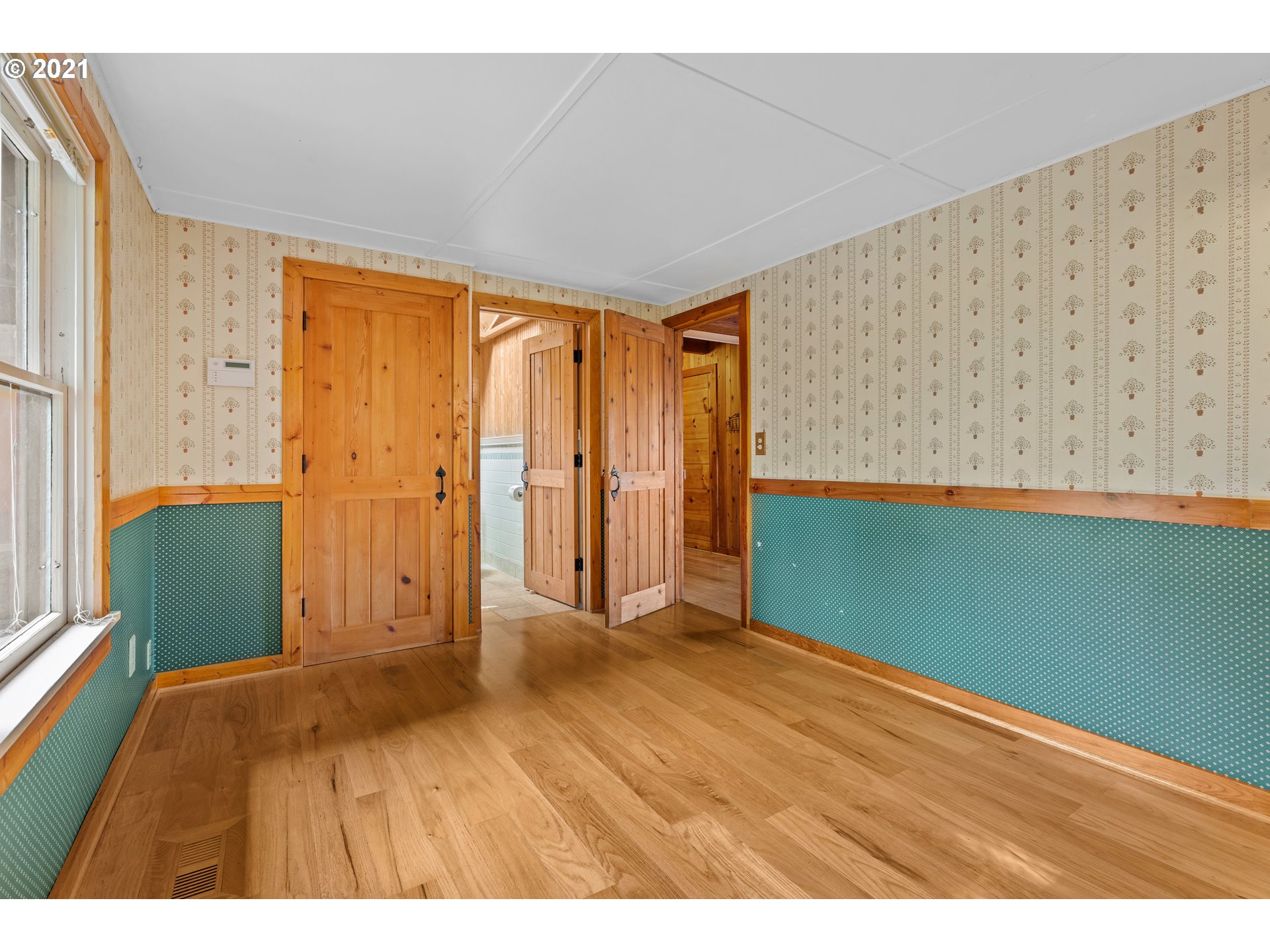 3740 Southwest Caldew Street Portland, OR 97219 - Photo 10 of 28 a view of an empty room with wooden floor