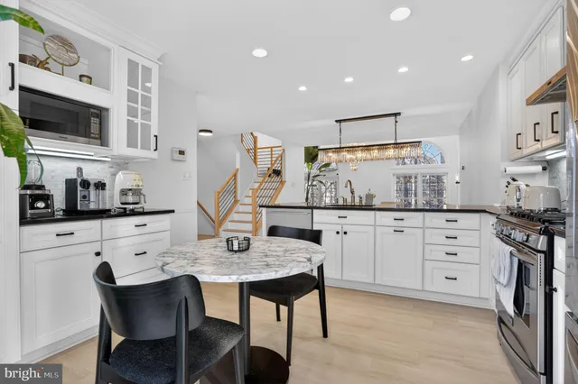 a kitchen with white cabinets and appliances