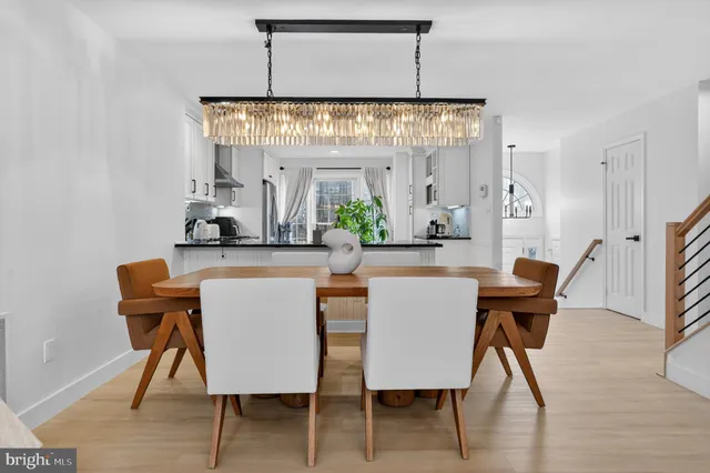 a view of a dining room with furniture and chandelier