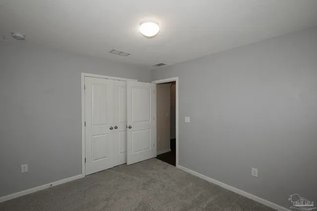 an empty room with closet area