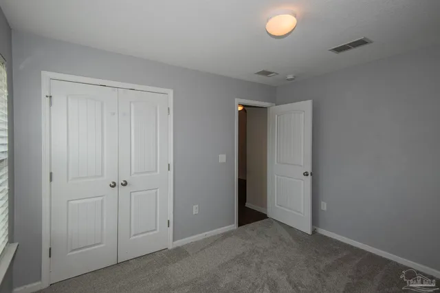 an empty room with closet area