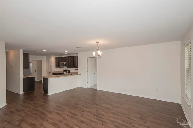 a view of a kitchen with a sink and a refrigerator