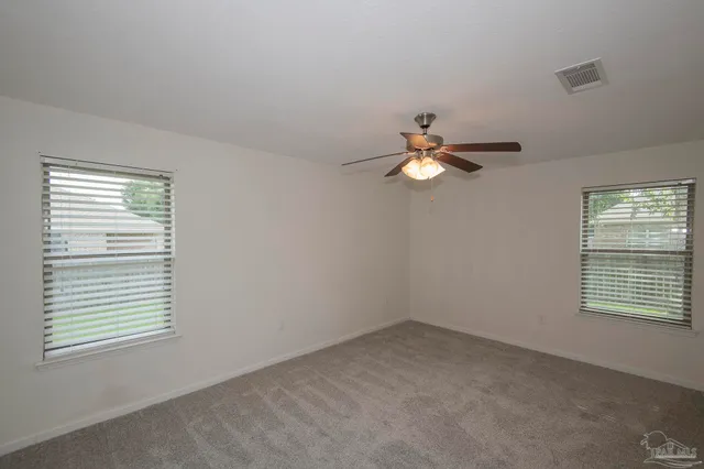 a view of a livingroom with a ceiling fan and window