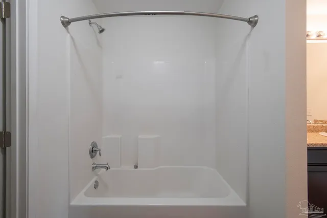 a bathroom with a shower and a bath tub